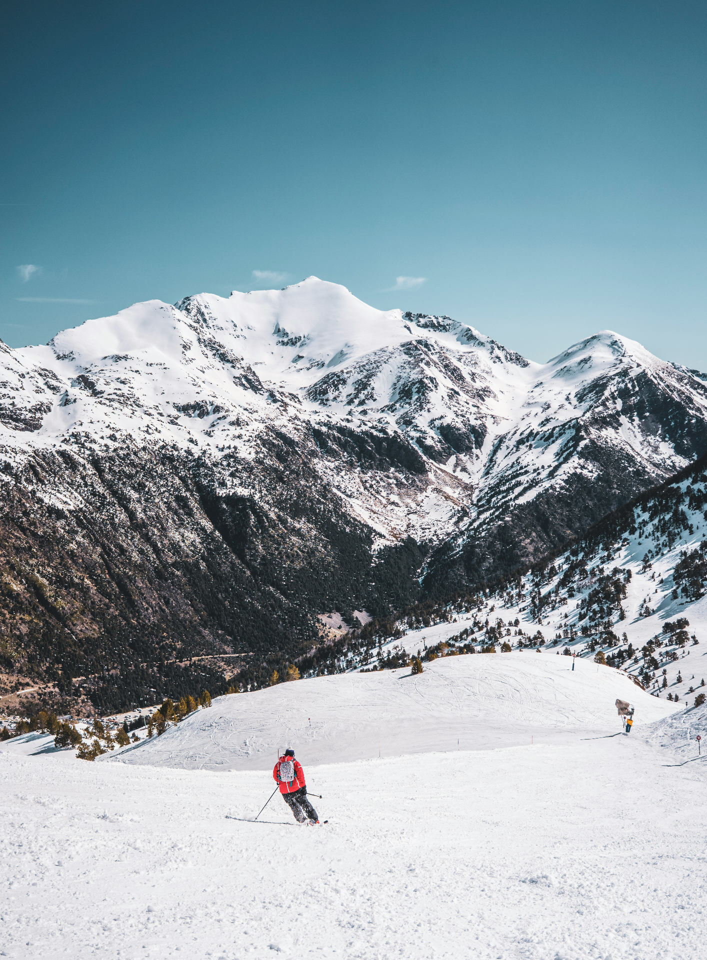 Skier descending a snowy slope in Andorra